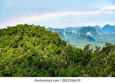 Panoramic view of rainbow over limestone karst mountains from Tiger Cave Temple, Krabi, Thailand