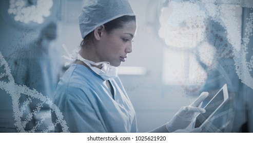 Panoramic view of red dna pattern on screen against female surgeon using digital tablet in operation room