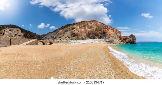 Panoramic view of the remote beach of Thiorichia on the island of Milos, Cyclades, Greece, with the abandoned sulphur Mines on land and emerald sea