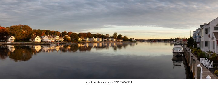 Panoramic view of residential homes by the Mystic River during a vibrant sunrise. Taken in Mystic, Stonington, Connecticut, United States.