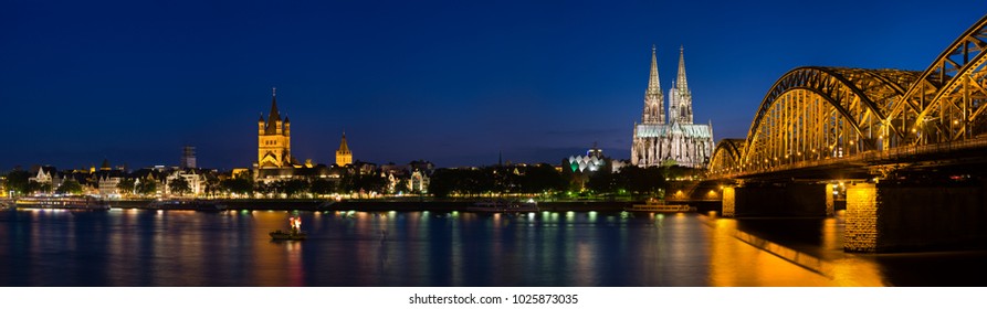 Panoramic View At The Rhine River In Cologne With St. Martins Curch, Cologne Cathedral And Hohenzollern Bridge.