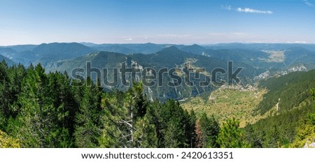 Panoramic view of the Rhodope Mountains from the observation deck in the area of Wolf Stone (Valchi Kamak) above the village of Gyovren, Bulgaria. Summer landscape from Bulgaria Mountains.