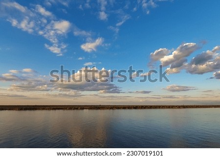  panoramic view of rio Paraná in late afternoon with reflection of clouds in water , Rosário, Santa fe, Argentina