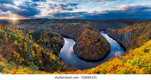 Panoramic view of river canyon with dark water and autumn colorful forest. Horseshoe bend, Vltava river, Czech republic. Beautiful landscape with river. Maj lookout. - Shutterstock ID 518585131