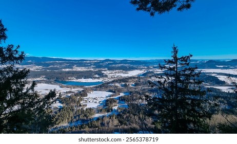 Panoramic view of river Drau in Rosental Valley in seen from mount Petelin in Faak, Carinthia, Austria. Alpine landscape in winter wonderland. Austrian Alps covered in snow. Serenity and calmness - Powered by Shutterstock