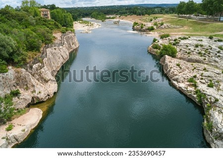 Panoramic view of River Gardon seen from ancient old Roman Aqueduct Pont du Gard ear Vers-Pon-du-Gard, Occitanie, France, Europe. Unesco world heritage site near Nimes, Languedoc-Roussillon