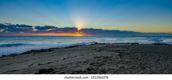 Panoramic View Of A Rocky Florida Beach As The Sun Rises 