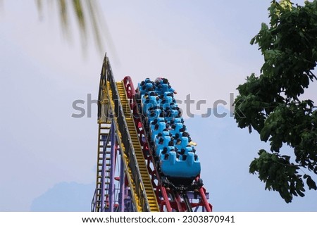 Panoramic view of a rollercoaster ride with sharp turns and twists on a sunny summer evening in Dufan, Dunia Fantasi, Fantasy World, Jakarta Indonesia