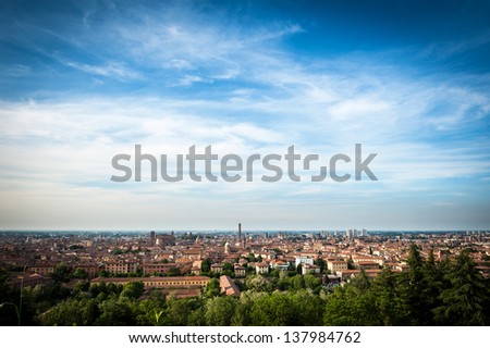 Panoramic view of the roofs of Bologna with blue sky.