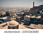 Panoramic view of roofs, mosques and historic buildings of mesopotamian city of Mardin, Turkey. Mardin roofs opposite Mesopotamian plain at background