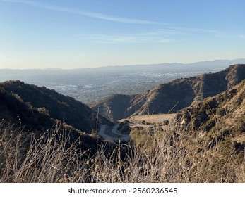 Panoramic view of rugged hills leading to a sprawling cityscape - Powered by Shutterstock