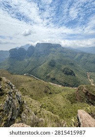 Panoramic view of rugged mountain range and valley in Blyde River Canyon, Mpumalanga, South Africa.