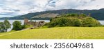 Panoramic view of the ruins of Urquhart Castle on the shore of massive Loch Ness, Scotland, UK