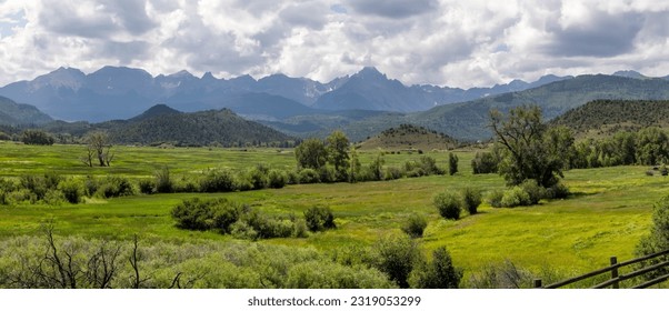 Panoramic view of scenic valley near Continental divide in Colorado with Sanjuan mountains in background.