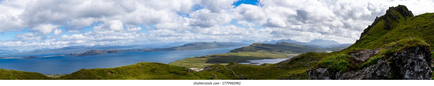 Panoramic view of Scottish Highlands from the Old Man of Storr with overview at Scottish mountains and sea in the background under cloudy sky - Shutterstock ID 1779982982