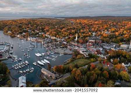 Panoramic view of sea harbor Camden, Maine town on east coast in New England, USA during sunrise in autumn season with fall foliage landscape