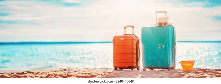 Panoramic view of the seacoast with suitcases on the sandbeach. - Powered by Shutterstock