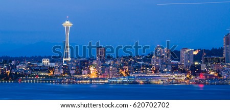 Panoramic view of Seattle downtown with Space Needle iconic from Alki Beach at blue hour . Panorama cityscape and urban architecture background.