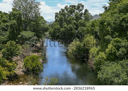 Panoramic view of the serene Bhavani River winding through lush green landscapes in Western Ghats, Tamil Nadu, India. Serene freshwater river photography highlighting South Indian natural beauty
