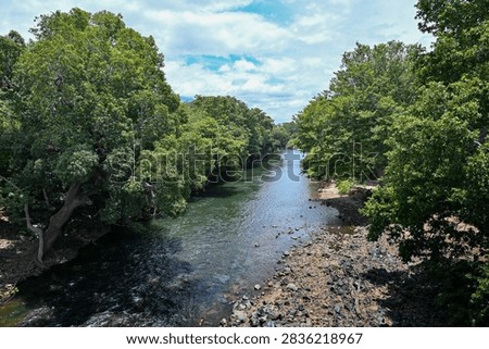 Panoramic view of the serene Bhavani River winding through lush green landscapes in Western Ghats, Tamil Nadu, India. Serene freshwater river photography highlighting South Indian natural beauty