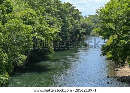 Panoramic view of the serene Bhavani River winding through lush green landscapes in Western Ghats, Tamil Nadu, India. Serene freshwater river photography highlighting South Indian natural beauty
