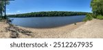 Panoramic view of a small beach off of the Mississippi river on a beautiful summer day