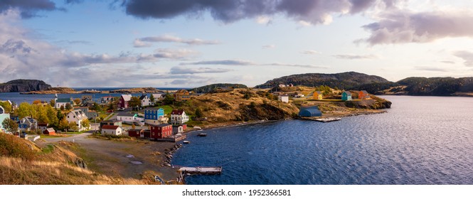 Panoramic view of a small town on the Atlantic Ocean Coast. Dramatic Colorful Sunrise Sky Art Render. Taken in Trinity, Newfoundland and Labrador, Canada.