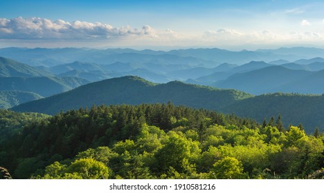 A panoramic view of the Smoky Mountains from the Blue Ridge Parkway in North Carolina. Blue sky with  clouds over layers of green hills and  mountains.  Copy space. North Carolina. 