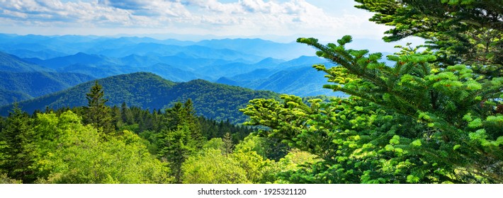 A Panoramic View Of The Smoky Mountains From The Blue Ridge Parkway In North Carolina. Blue Sky With Clouds Over Layers Of Green Hills And Mountains. North Carolina. Image For Banner And Web Header.