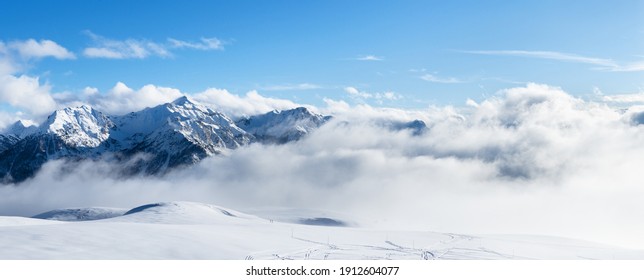 Panoramic view of snowy mountains. Mountain ski resort, snow slope. Winter vacation.