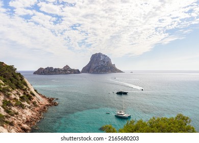 Panoramic view from the southern edge of Cola d'Hort bay to 2 small cliff islands Es Vedra and Es Vedranell, Ibiza, Balearic Islands, Spain