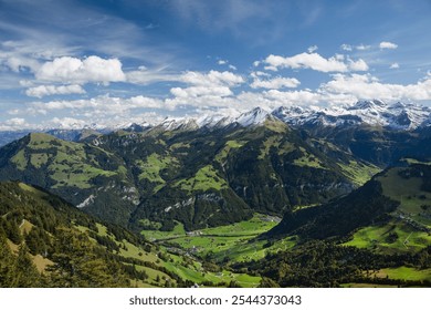 Panoramic view from Stanserhorn, revealing Switzerland dramatic Alpine landscape with snow-covered peaks and lush green valleys. Clear skies highlight the contrast between rocky mountains and vibrant - Powered by Shutterstock