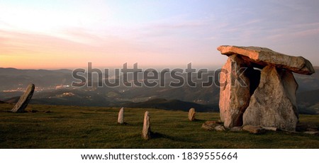 Panoramic view of the sunset in the Urdaibai Biosphere Reserve from the top of Mount Oiz, with a dolmen in the foreground