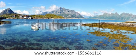 Panoramic view from Svolvaer airport at coastline of Vestfjord. Husvagen farm buildings and mountain landscape of Austvagoya island are at background. Lofoten archipelago, Nordland, Northern Norway.