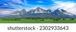 Panoramic view of Tatra mounains. Landscape of High Tatras in the spring. Snowy mountain tops and beautiful sky.