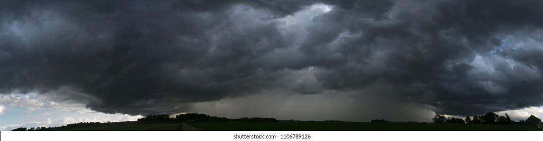 panoramic view of a terrifying dark thunderstorm approaching