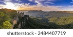 A panoramic view of the Three Sisters rock formation in the Blue Mountains, Australia. The photo was taken from the scenic Echo Point Lookout overlooking the vast mountain landscape.