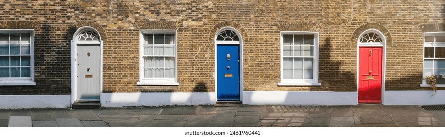 A panoramic view of three vibrant colored doors