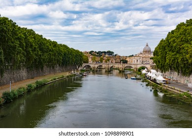 Panoramic view of Tiber river with Saint Peter's Dome at distance in Rome, Italy