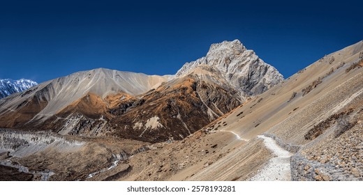 Panoramic view of the Tilicho base camp and wide trekking route to it in sunny autumn day. Annapurna circuit trekking, Nepal.