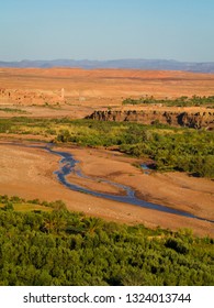 A Panoramic View From The Top Of The Ancient Ksar Of Ait Ben Haddon, A Unesco Old Fortress Full Of Kasbah In The Desert Of Morocco; Beautiful View Of River And Valley By Sunset.