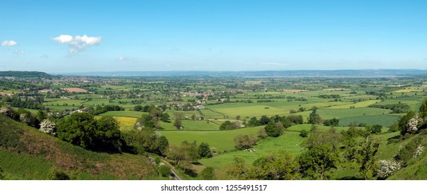 Panoramic view towards the River Severn and The Forest of Dean over a patchwork of fields, Coaley Peak Picnic Site and Viewpoint, Gloucestershire, UK - Shutterstock ID 1255491517