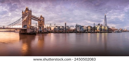 Panoramic view of Tower Bridge and River Thames with dramatic sky at sunrise, London, England, United Kingdom, Europe