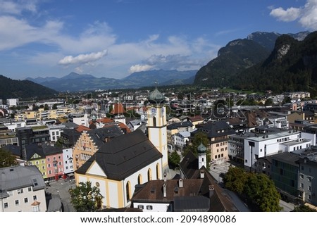 A panoramic view of the town of Kufstein in Tyrol, Austria. The city is located in the Inn Valley and is the border town to Kiefersfelden, Germany. In the foreground the parish church of St. Vitus and
