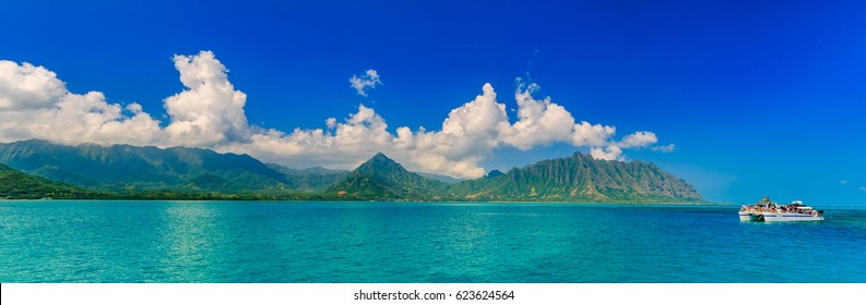 Panoramic View Of A Tropical Lagoon, Lush Mountains And A Catamaran In Contrast With The Ocean In Oahu, Hawaii