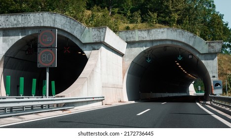 Panoramic view of tunnel entrance in Europe. Landscape of highway road and mountain forest.