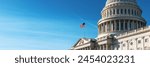 Panoramic view of the United States Capitol dome with its flag against a blue sky.