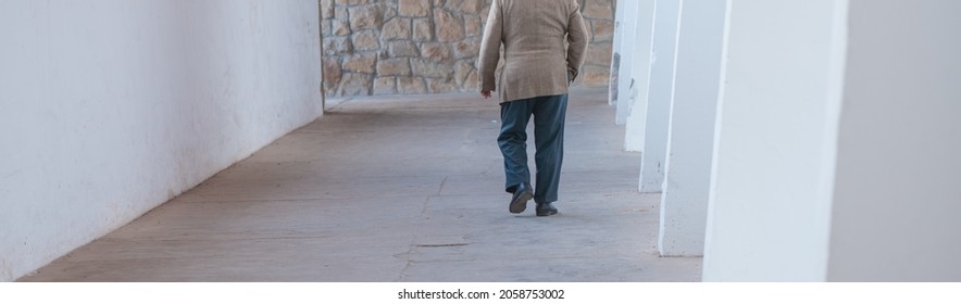 A Panoramic View Of Unrecognizable Male Elderly Walking Away