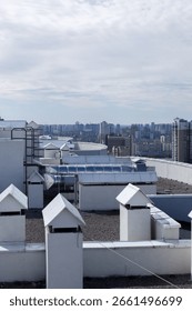 A Panoramic View of Urban Rooftops Surrounded by Modern High-Rise Buildings and a Beautiful Cloudy Sky