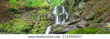 panoramic view to waterfall in canyon